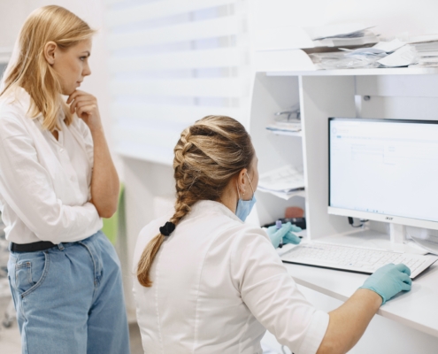 Two medical professionals looking at a computer screen. Header image for an article about finding the best technology solution for medical offices